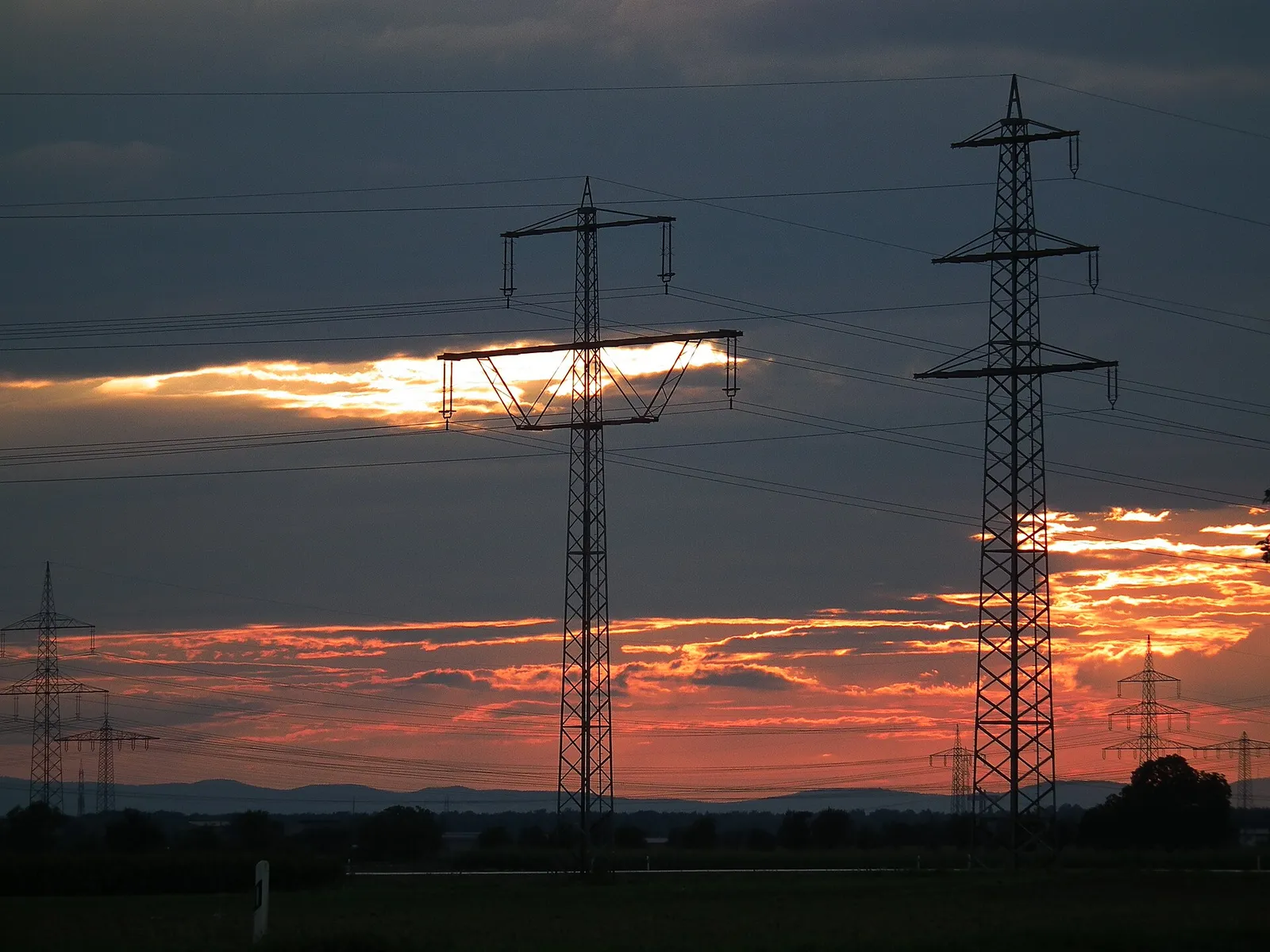 Hochspannungsmasten bei Sonnenuntergang (Symbolbild)